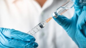 hands of a healthcare professional holding a syringe, symbolizing vaccine